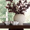 The Fullbright Vase, with its rippling terracotta spirals and eggshell glaze, evokes the timeless elegance of a Nautilus shell.