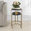 A glamorous set of nesting tables by Uttermost with oval tops and an antique brass finish