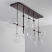 Black gunmetal industrial chandelier with multiple arms and clear glass globes