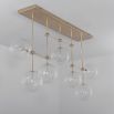 Natural brass finish industrial style chandelier with hanging clear glass globes