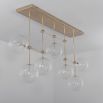 Natural brass industrial style chandelier with hanging clear glass globes