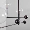 Black gunmetal finish chandelier with rotational arm fixture and clear glass globe design