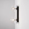 A chic, double light wall lamp with glass lampshades and a black gunmetal finish