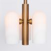 Contemporary retro style pendant ceiling light in a natural brass finish with translucent glass lampshade design