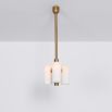 Contemporary retro style pendant ceiling light in a natural brass finish with translucent glass lampshade design