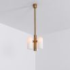 Contemporary retro style pendant ceiling light in a natural brass finish with translucent glass lampshade design