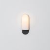 Luxurious black gunmetal brass wall lamp with a long translucent glass shade