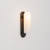 Contemporary solid brass wall lamp in a black gunmetal finish with a long translucent glass lampshade
