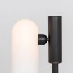 A luxe, industrial black gunmetal table lamp with triplex opal glass