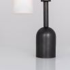 A luxe, industrial black gunmetal table lamp with triplex opal glass