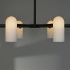 A luxury statement chandelier with a round structure, frosted glass shades and a black gunmetal finish