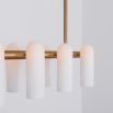 Contemporary natural brass finish chandelier with a colonnade of translucent glass lampshades 