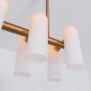 Contemporary natural brass finish chandelier with a colonnade of translucent glass lampshades 