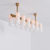 Contemporary natural brass finish chandelier with a colonnade of translucent glass lampshades 