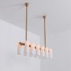 Contemporary natural brass finish chandelier with a colonnade of translucent glass lampshades 