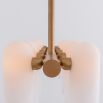 Contemporary natural brass finish chandelier with a colonnade of translucent glass lampshades 