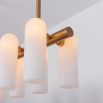 Contemporary natural brass finish chandelier with a colonnade of translucent glass lampshades