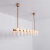 Contemporary natural brass finish chandelier with a colonnade of translucent glass lampshades