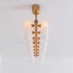 Contemporary natural brass finish chandelier with a colonnade of translucent glass lampshades