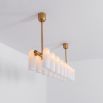 Contemporary natural brass finish chandelier with a colonnade of translucent glass lampshades