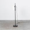 A glamorous industrial black gunmetal floor lamp with a triplex opal lampshade