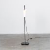 A glamorous industrial black gunmetal floor lamp with a triplex opal lampshade