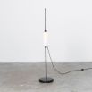 A glamorous industrial black gunmetal floor lamp with a triplex opal lampshade