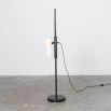 A glamorous industrial black gunmetal floor lamp with a triplex opal lampshade