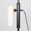 A glamorous industrial black gunmetal floor lamp with a triplex opal lampshade