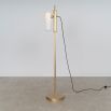 A glamorous industrial lacquered burnished brass floor lamp