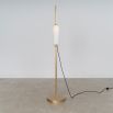 A glamorous industrial lacquered burnished brass floor lamp