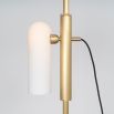 A glamorous industrial lacquered burnished brass floor lamp