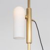 A glamorous industrial lacquered burnished brass floor lamp