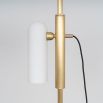 A glamorous industrial lacquered burnished brass floor lamp