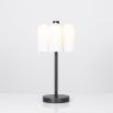 A bold black gunmetal LED table lamp with six triplex opal glass lampshades