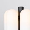 A bold black gunmetal LED table lamp with six triplex opal glass lampshades