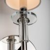 A sophisticated contemporary-style wall sconce in polished nickel with an off white shade