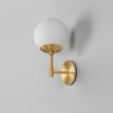 A glamorous wall lamp by Schwung with a spherical glass shade and beautiful brass base