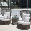A stylish outdoor side table from Willow's Outdoor collection with a glass table top and woven base