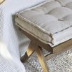 Vintage-style, wooden bench with a linen cushion