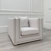 Boxy armchair with sumptuous grey mist upholstery and glamorous studding details 