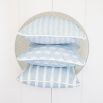 A calming light blue children's cushion with a white pattern and piping