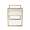 A chic boucle bench with a stylish brass frame