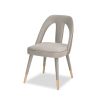 A luxury dining chair by Liang & Eimil with a gorgeous grey upholstery and brass detailing