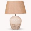 A costal, cottage-inspired table lamp with a natural linen shade