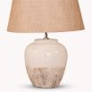 A costal, cottage-inspired table lamp with a natural linen shade