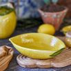 A ceramic serving bowl shaped like a lemon, with textured finish 