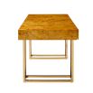 A classic burled mappa desk with a polished brass base