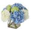 Bouquet of blue, green and white hydrangea in clear glass pot
