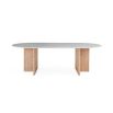 A luxurious dining table by Jonathan Adler with a white Carrara marble top and T-shaped legs crafted from solid oak 